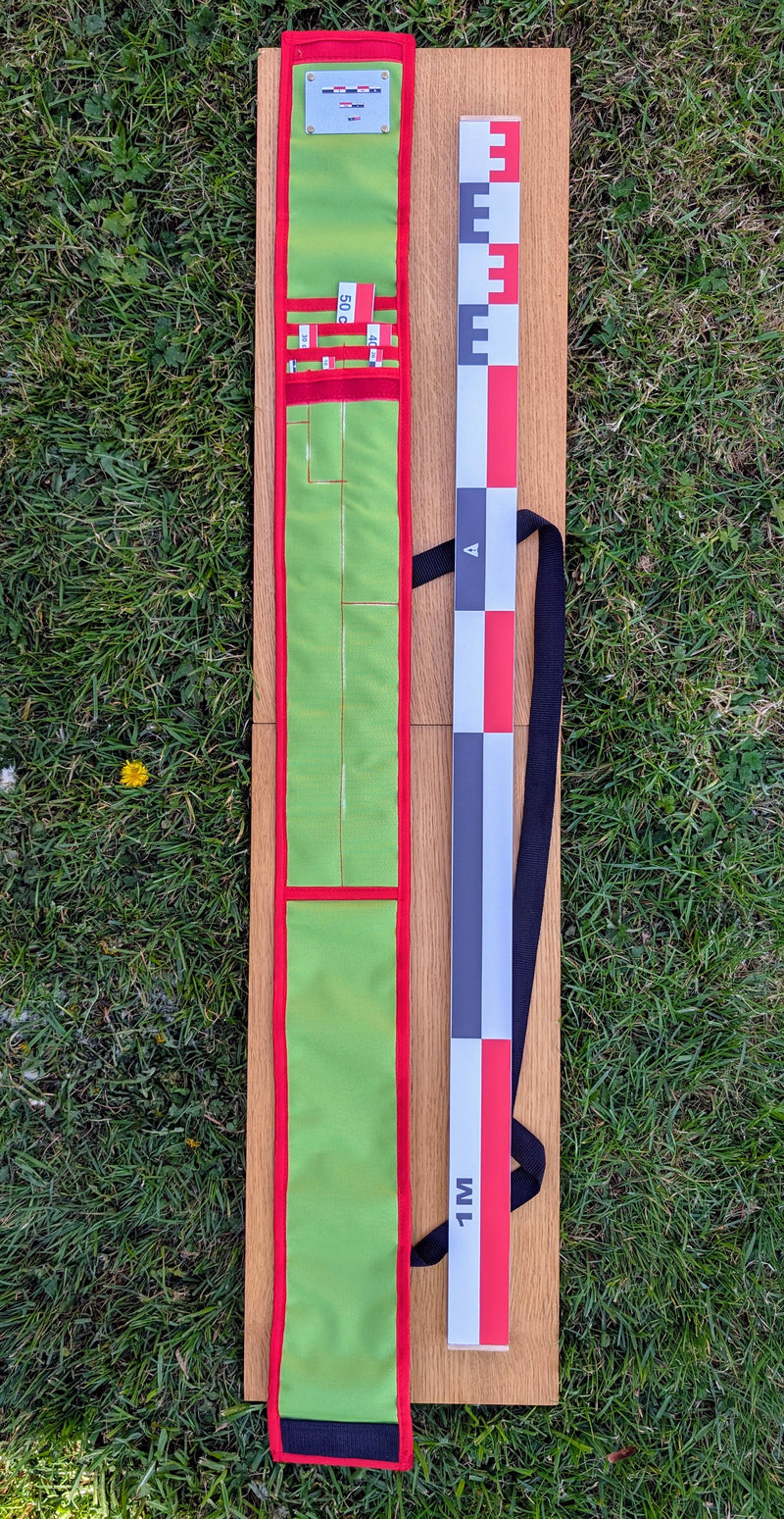 Load image into Gallery viewer, CAMA 100 cm archaeological photo scale kit with red-white-black scales and open green case on wooden board