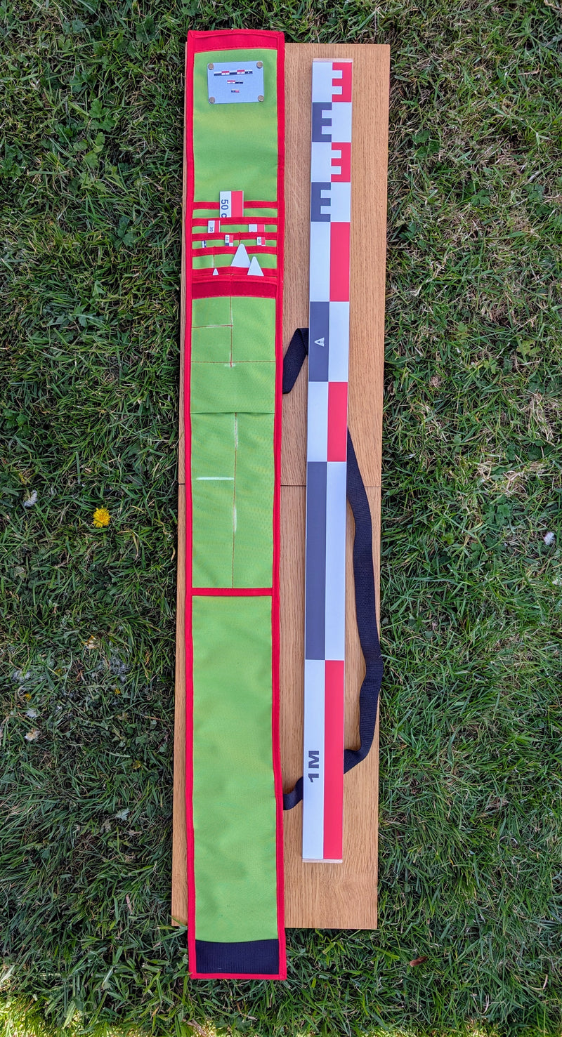 Load image into Gallery viewer, CANOMA 100 cm archaeological photo-scale kit with open green case, red-white-black scales and north arrows on grass