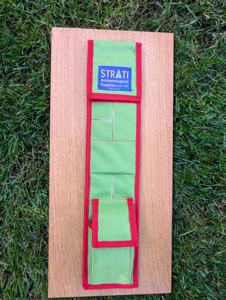 Chargez l'image dans la visionneuse de la galerie, Open green and red CANVAS 50 cm STRATI roll-up case with organized pockets on light wood over grass