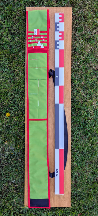 Chargez l'image dans la visionneuse de la galerie, CANO 100 cm archaeological photo-scale kit with red-white-black scales and north arrows in open green case on grass