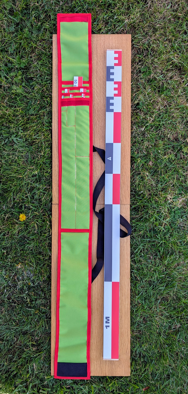 Load image into Gallery viewer, CASE 100 cm archaeological photo scale kit with red-white-black metric scales and STRATI green case on wood