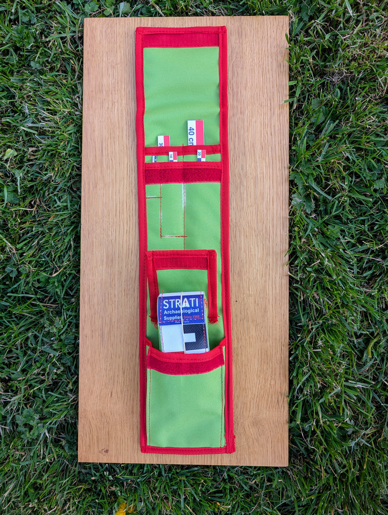 Load image into Gallery viewer, Open CASE 40 cm CANVAS photo scale kit in a green and red Strati roll case on a wooden board