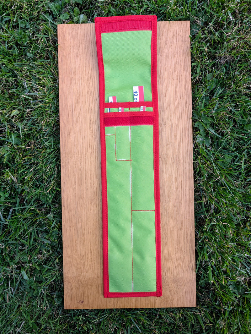 Load image into Gallery viewer, Open green STRATI fabric carrying case with red trim for archaeology photo scales, laid flat on wood over grass