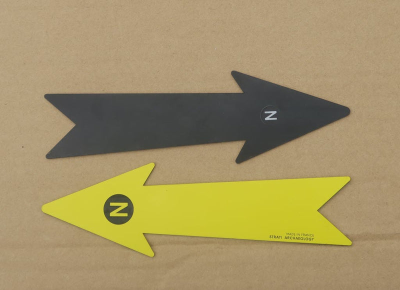 Load image into Gallery viewer, 21 cm black and yellow archaeological north arrows with N markers on a cardboard background