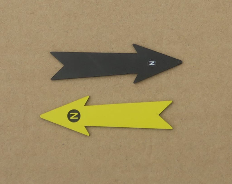 Load image into Gallery viewer, 7 cm black and yellow archaeological north arrows with N markers on a cardboard background