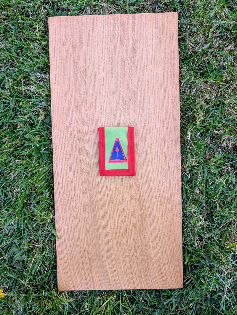 Load image into Gallery viewer, Closed Strati MicroMagnet red-white-black magnetic scale pouch with red border on wood over grass