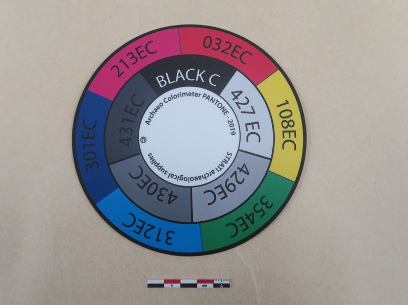 Load image into Gallery viewer, Large circular Strati SCD colorimeter disk with multicolor and greyscale Pantone segments on beige background