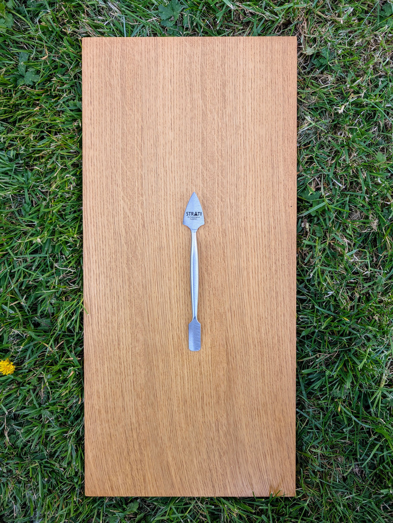Load image into Gallery viewer, Small forged stainless steel dual-ended spatula with brushed finish on light oak board over grass