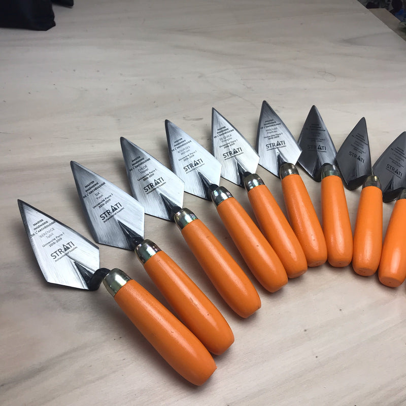 Load image into Gallery viewer, Set of custom engraved archaeological trowels with orange handles and steel blades arranged on light tabletop