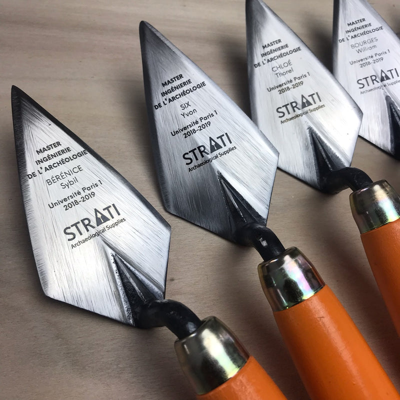 Load image into Gallery viewer, Custom engraved archaeological trowels with orange wooden handles and brushed steel blades on light wood surface