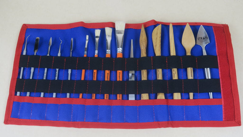 Load image into Gallery viewer, Open red and blue SCADS three-section tool roll with sculpting tools, metal picks and brushes on beige background