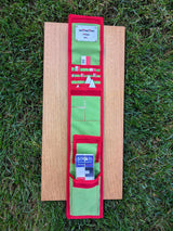 Open CANOMA 50 cm canvas archaeological kit on grass with green red tool roll, wooden planks, red white scale rulers and white north arrows