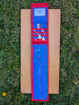 Open CANOMA 50 cm black-white archaeological photo-scale kit with north arrows in blue and red case on wood