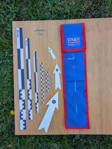 CANOMA 50 cm black-white archaeological scale set with north arrows and open blue-red case on wood and grass