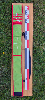 CANO 100 cm archaeological photo-scale kit with red-white-black scales and north arrows in open green case on grass
