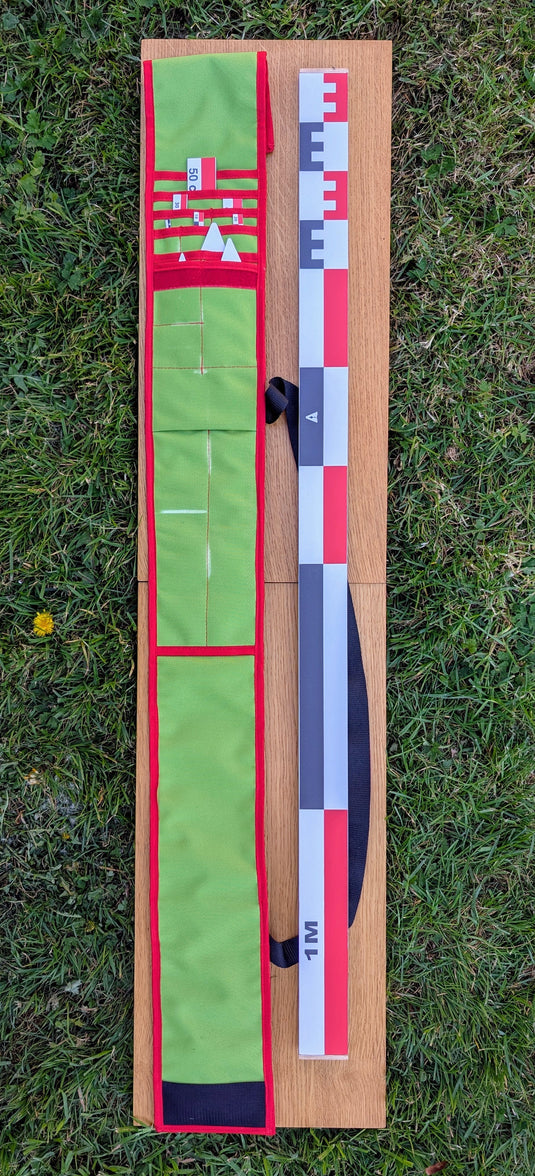 CANO 100 cm archaeological photo scale kit with 1 m red-white-black scale and green carrying case on wood