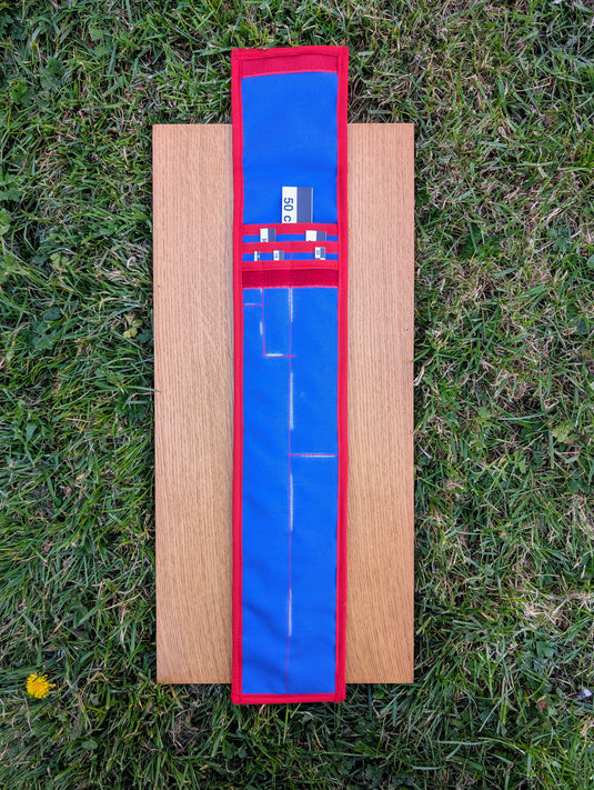 CASE 50 cm black and white archaeological photo scales with open blue and red storage case on wood