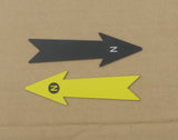 13 cm black and yellow archaeological north arrows with N markers on a cardboard background