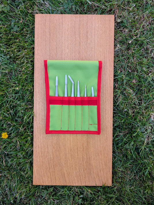 Open green Strati case with six stainless steel precision tweezers stored in individual slots