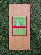 Open green Strati case with six stainless steel precision tweezers stored in individual slots