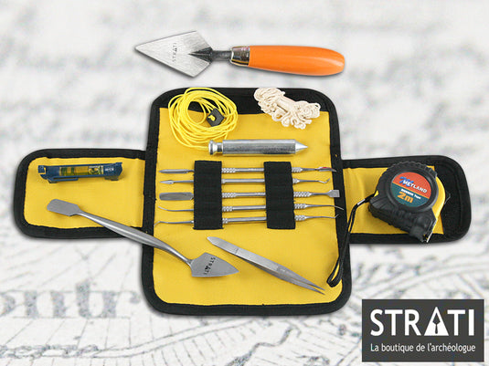 Classic archaeology field tool kit with trowels, measuring tape, plumb bob, cord and precision tools in a yellow case