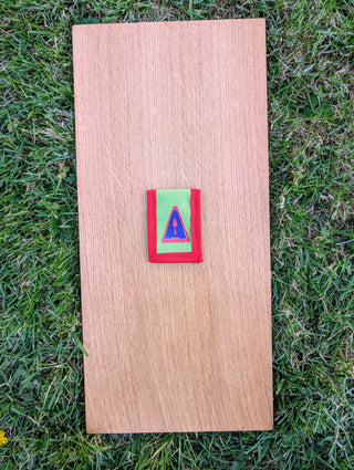Chargez l'image dans la visionneuse de la galerie, Closed Strati MicroMagnet red-white-black magnetic scale pouch with red border on wood over grass

