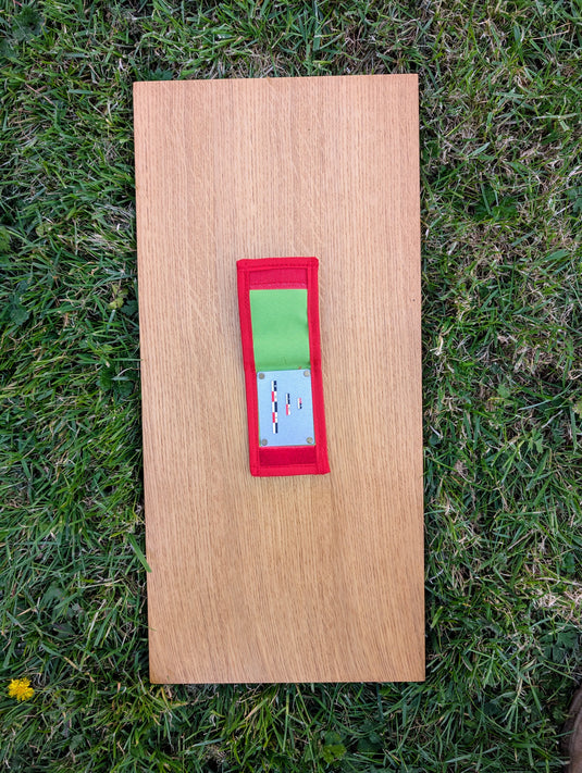 Open Strati MicroMagnet red-white-black magnetic scale set in red and green pouch on wood over grass