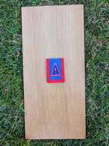 Closed Strati MicroMagnet black-white magnetic scale pouch with red and blue fabric on wood over grass