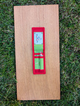 Open Strati Minimix+ red-white-black compact case with small archaeological photo scales on wood over grass