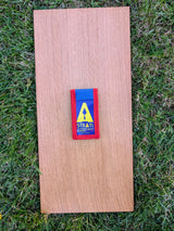 Closed Strati Minimix+ blue and red archaeological pouch with yellow logo on wood over grass