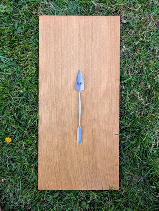 Chargez l'image dans la visionneuse de la galerie, Forged stainless steel dual-ended spatula with brushed finish on light oak board over green grass
