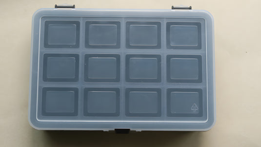 Transparent storage box for archaeological letter board letters and numbers with grey compartments on a light background